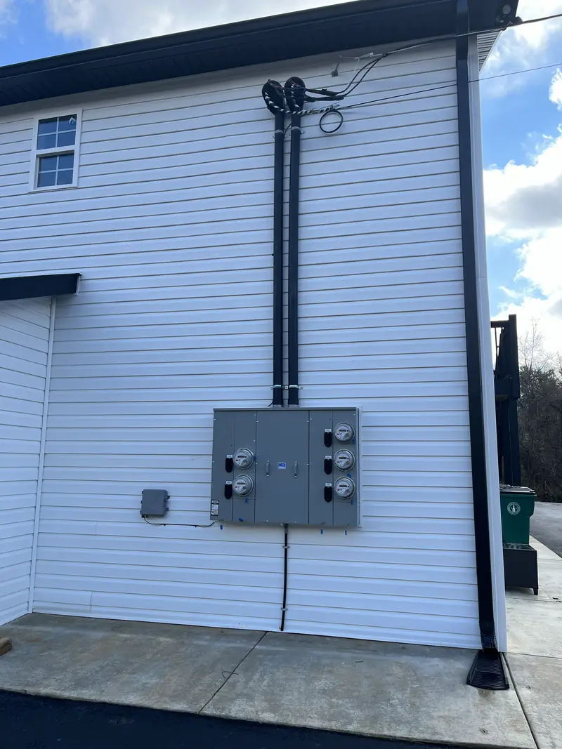 Barkley Apartment Project: exterior wall with electrical meters and conduit