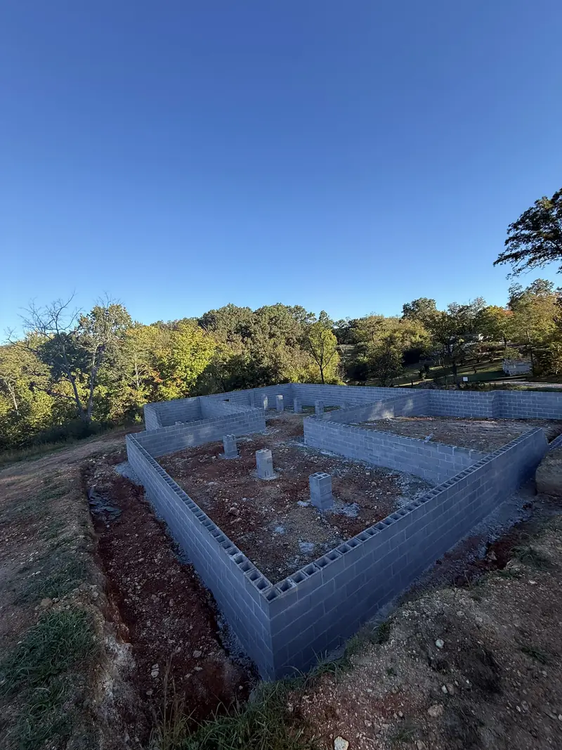 Block crawl space foundation with piers on a wooded lot
