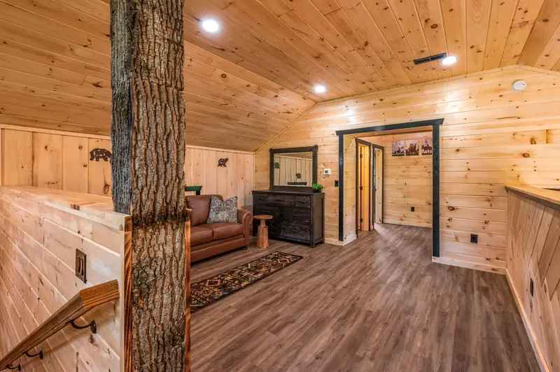 Cabin Project: log cabin-style bedroom with wood-paneled walls and ceiling