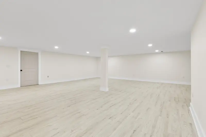 Hoppers Bluff spec home, Rutledge, TN: room with recessed lighting, light wood flooring and a beige door