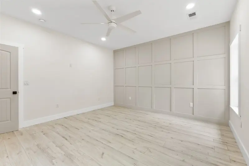 Hoppers Bluff spec home, Rutledge, TN: room with a decorative paneled wall, wood flooring and a large window