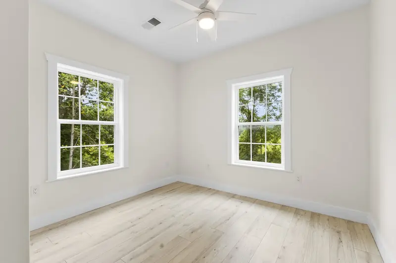 Hoppers Bluff spec home, Rutledge, TN: room with two large windows and light hardwood floors