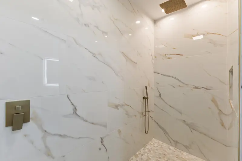 Hoppers Bluff spec home, Rutledge, TN: walk-in shower with large white marble tile and a rain showerhead