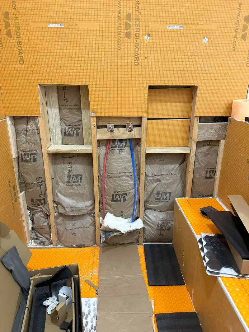 Bathroom remodel in progress: framed shower niche, insulation and waterproofing board