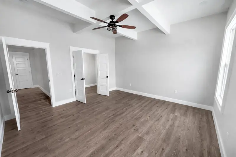 Shiloh Project: room with white walls, wood flooring and a ceiling fan