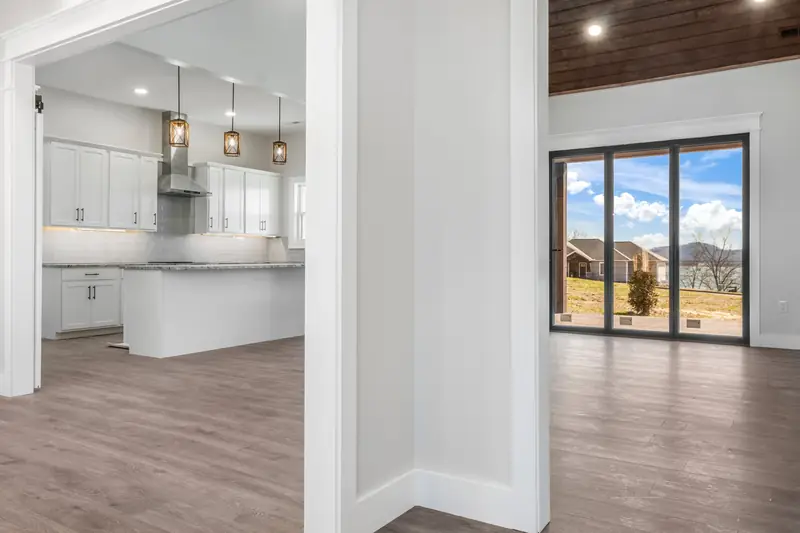 Shiloh Project: open kitchen and living space with a floor-to-ceiling window and mountain view