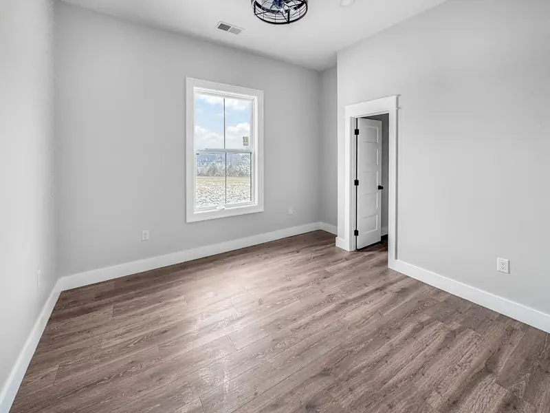 Shiloh Project: room with wood flooring and a window looking out to the view